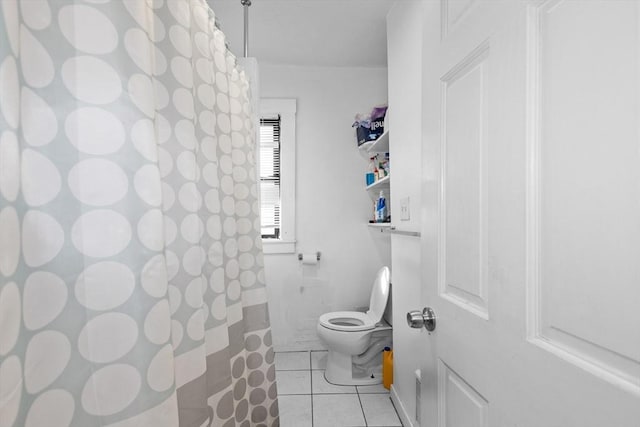 bathroom with tile patterned flooring and toilet