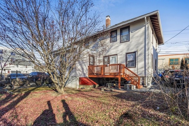 rear view of house featuring a deck