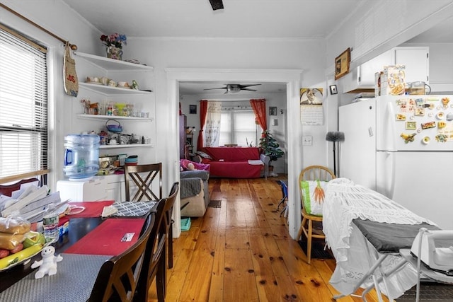 dining area featuring hardwood / wood-style flooring, plenty of natural light, ceiling fan, and ornamental molding