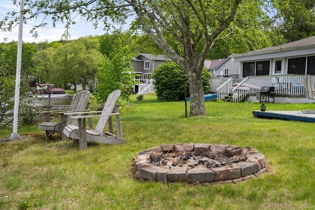 35 Island Rd, Holland, MA 01521 - view of grassy yard featuring a fire pit and a wooden deck
