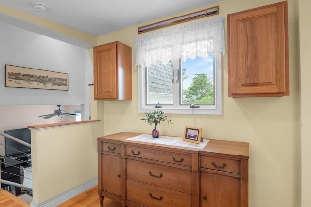 5 I St Unit 2, Newburyport, MA 01950 - kitchen featuring brown cabinetry, a ceiling fan, and light wood-style flooring