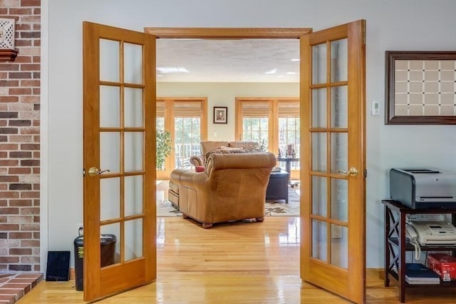 interior space featuring light wood-type flooring and french doors