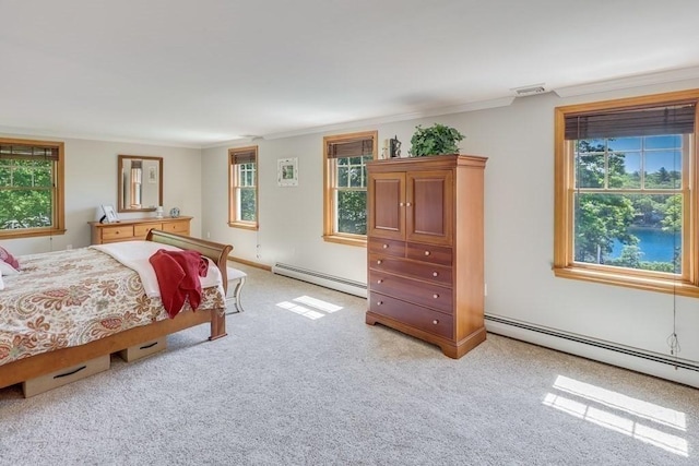 bedroom featuring multiple windows, a baseboard heating unit, and crown molding