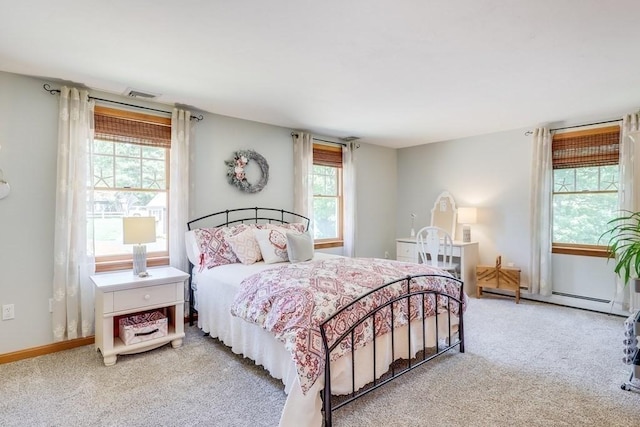 bedroom featuring a baseboard heating unit and carpet