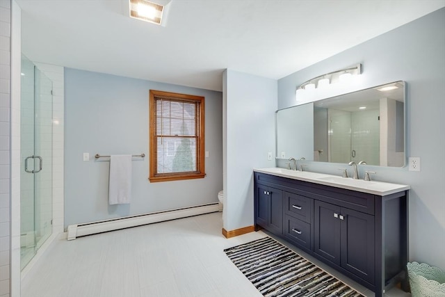 bathroom with walk in shower, a baseboard radiator, vanity, and toilet