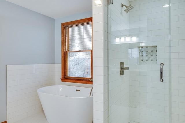 bathroom featuring independent shower and bath and tile walls