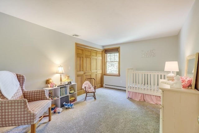 carpeted bedroom featuring a baseboard radiator and a closet