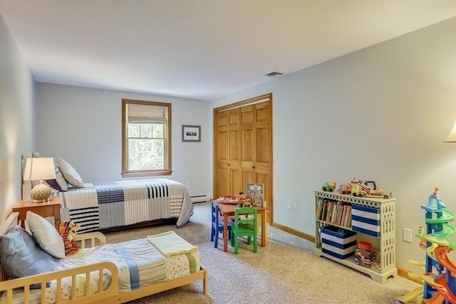 bedroom with light colored carpet and a baseboard radiator