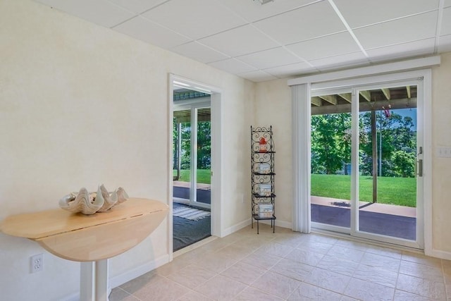 doorway featuring a drop ceiling and plenty of natural light