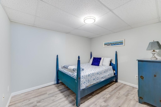 bedroom with hardwood / wood-style flooring and a drop ceiling