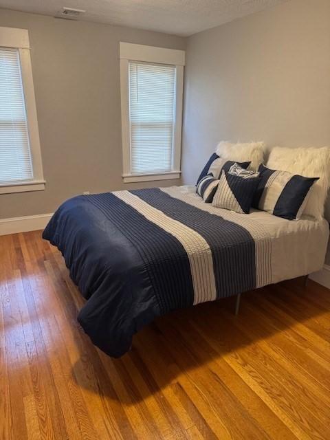 bedroom with hardwood / wood-style flooring