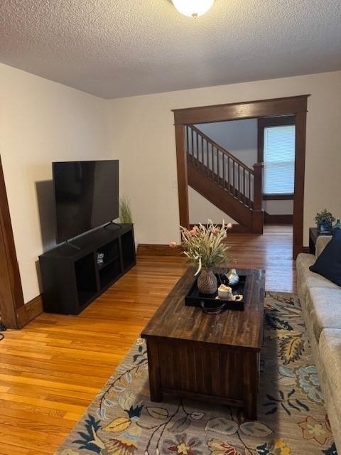 living room with hardwood / wood-style flooring and a textured ceiling