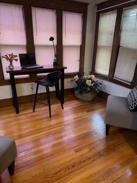 home office with light hardwood / wood-style flooring