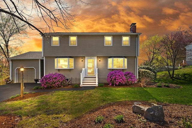 24 Hodgkins Dr, Ipswich, MA 01938 - colonial-style house featuring a garage, a chimney, a lawn, and driveway
