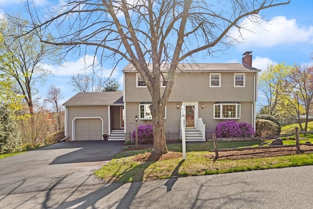 24 Hodgkins Dr, Ipswich, MA 01938 - colonial house featuring an attached garage, driveway, a chimney, and entry steps