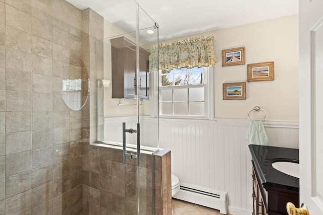 24 Hodgkins Dr, Ipswich, MA 01938 - bathroom with vanity, toilet, a wainscoted wall, a shower stall, and a baseboard radiator