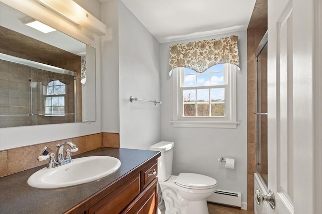 24 Hodgkins Dr, Ipswich, MA 01938 - bathroom featuring vanity, baseboard heating, toilet, and tiled shower