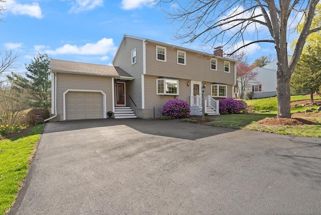 24 Hodgkins Dr, Ipswich, MA 01938 - colonial house with a garage, a chimney, driveway, and a front yard