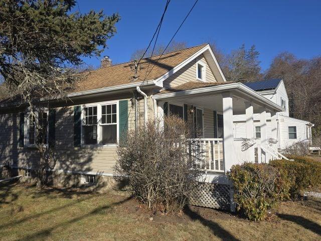 back of property featuring a lawn