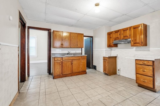 kitchen featuring light tile patterned floors, sink, and a drop ceiling