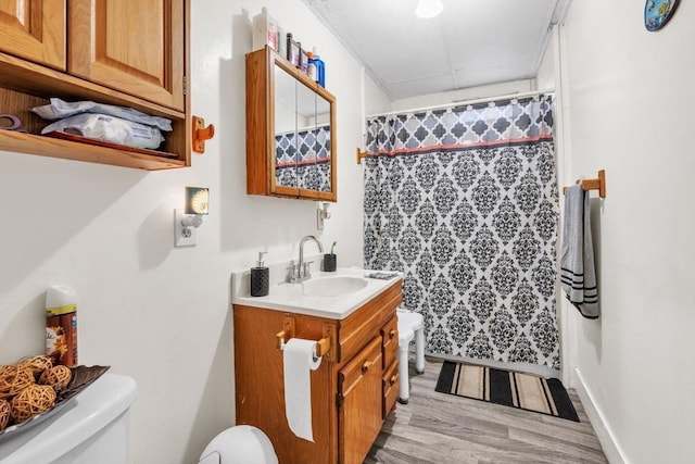 bathroom with hardwood / wood-style flooring, vanity, toilet, and a shower with curtain