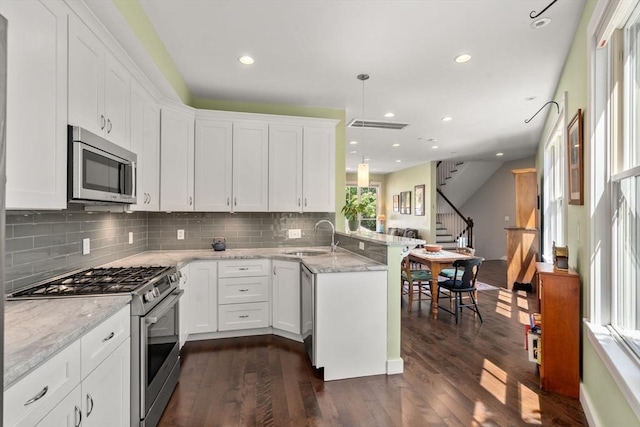 370 Beech St Unit 2, Boston, MA 02131 - kitchen featuring stainless steel appliances, a sink, a peninsula, backsplash, and recessed lighting