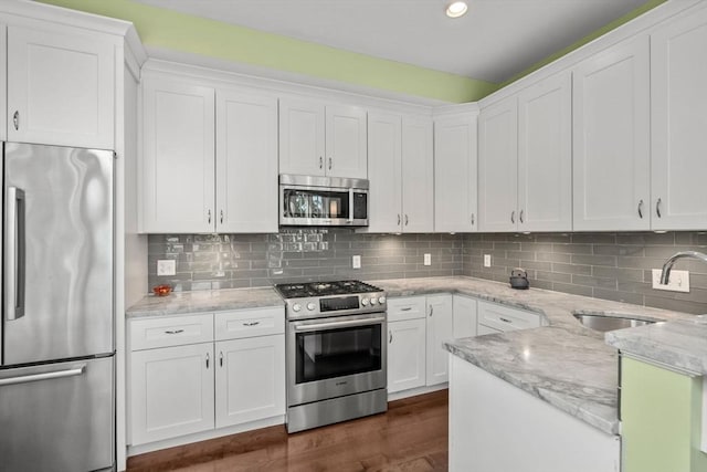 370 Beech St Unit 2, Boston, MA 02131 - kitchen featuring appliances with stainless steel finishes, a sink, white cabinets, and recessed lighting