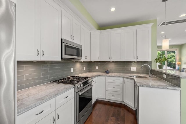 370 Beech St Unit 2, Boston, MA 02131 - kitchen with stainless steel appliances, a sink, a peninsula, dark wood-type flooring, and white cabinets
