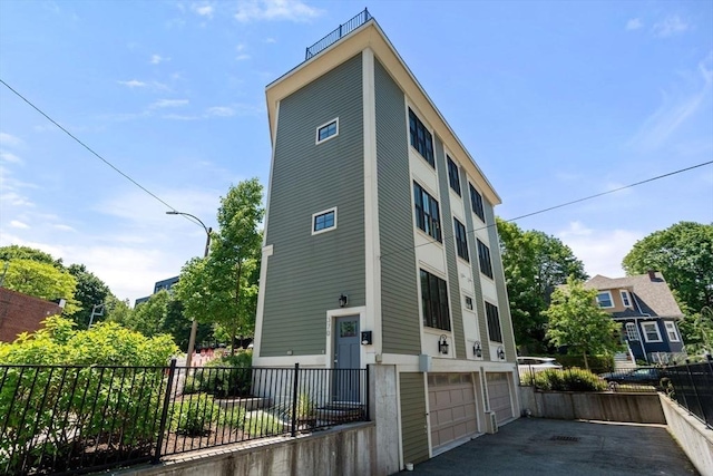 370 Beech St Unit 2, Boston, MA 02131 - back of house featuring an attached garage and asphalt driveway