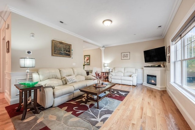 living room featuring light hardwood / wood-style floors and ornamental molding