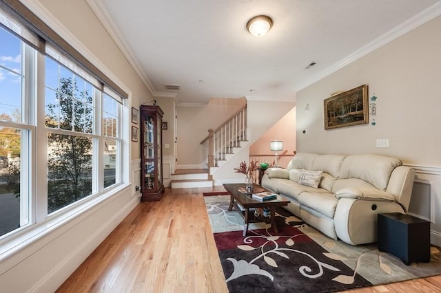 living room featuring wood-type flooring and ornamental molding