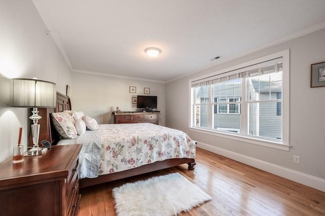 bedroom featuring crown molding and hardwood / wood-style flooring