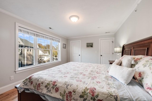 bedroom featuring wood-type flooring and ornamental molding