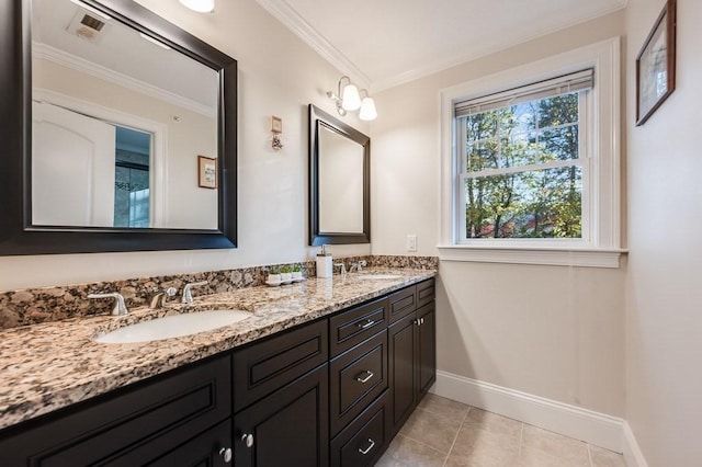 bathroom with tile patterned flooring, vanity, and crown molding