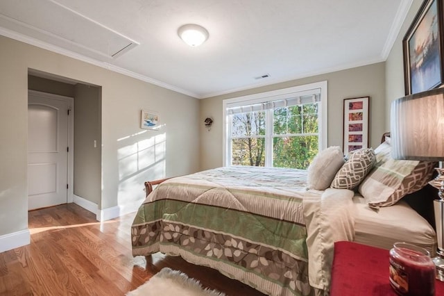 bedroom featuring light hardwood / wood-style floors and crown molding