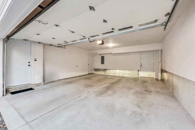 garage with electric panel and a garage door opener