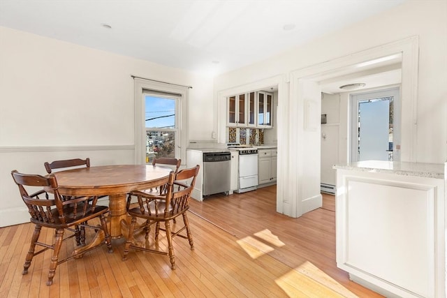 dining space featuring light wood-style flooring and baseboard heating