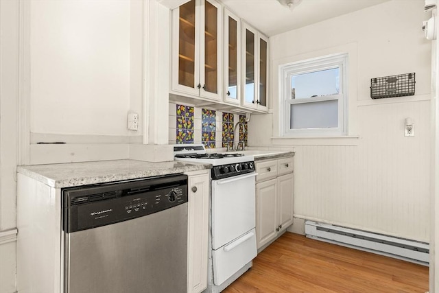 kitchen featuring white gas stove, light countertops, a baseboard heating unit, light wood-type flooring, and dishwasher