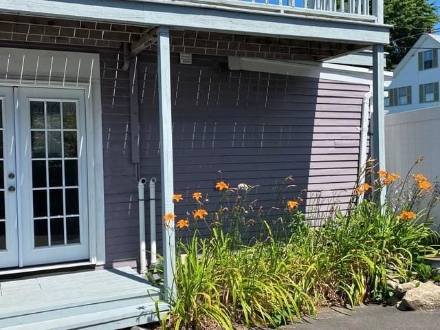 entrance to property with a balcony and french doors