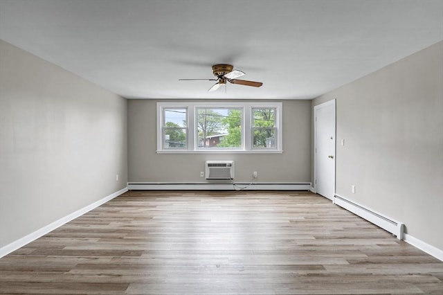 100 Magnolia Ave Unit 26, Lynn, MA 01904 - spare room featuring a baseboard heating unit, ceiling fan, wood finished floors, and baseboards