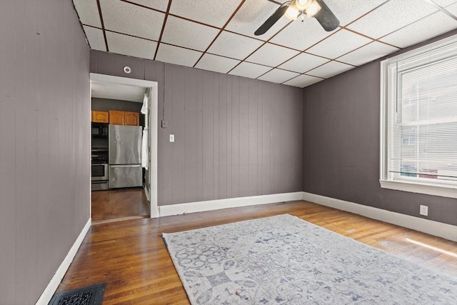 57 Bessom St, Lynn, MA 01902 - empty room featuring a drop ceiling, wood finished floors, and a ceiling fan