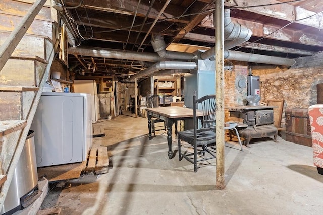 57 Bessom St, Lynn, MA 01902 - unfinished below grade area featuring washer / dryer and a wood stove