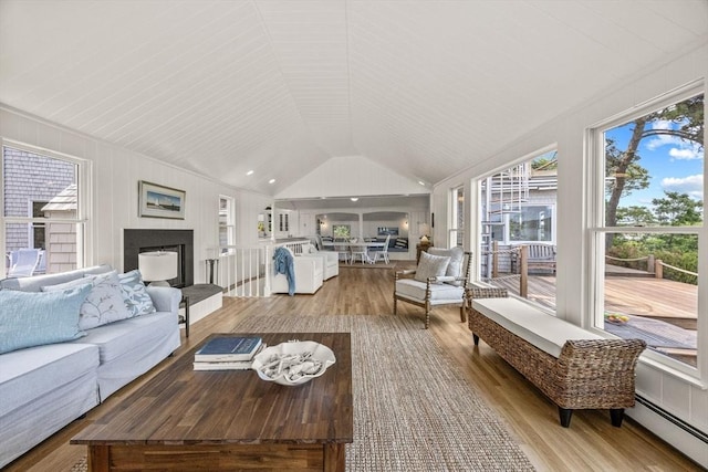 5 Kidd Way, Orleans, MA 02653 - living room with a baseboard heating unit, wood finished floors, a fireplace with raised hearth, and vaulted ceiling