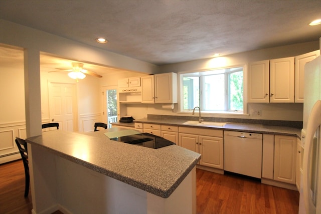 kitchen with white cabinets, white appliances, dark hardwood / wood-style flooring, and ceiling fan