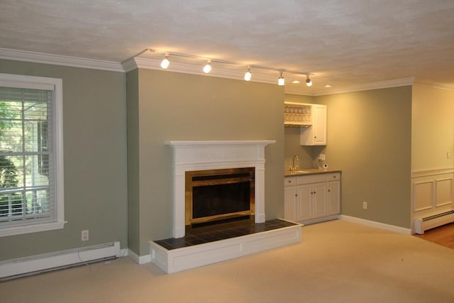 unfurnished living room with baseboard heating, a baseboard heating unit, a fireplace, crown molding, and light colored carpet