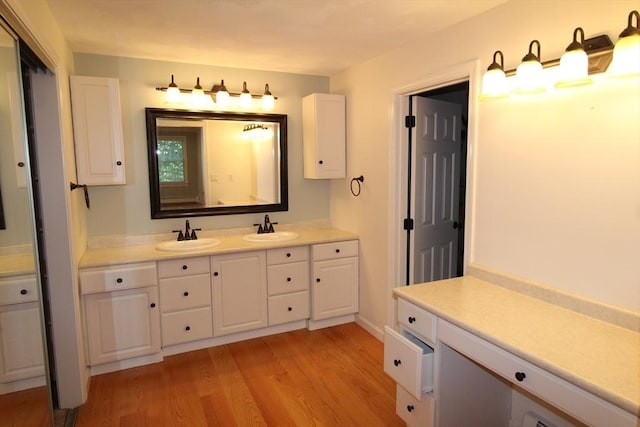 bathroom with wood finished floors and vanity