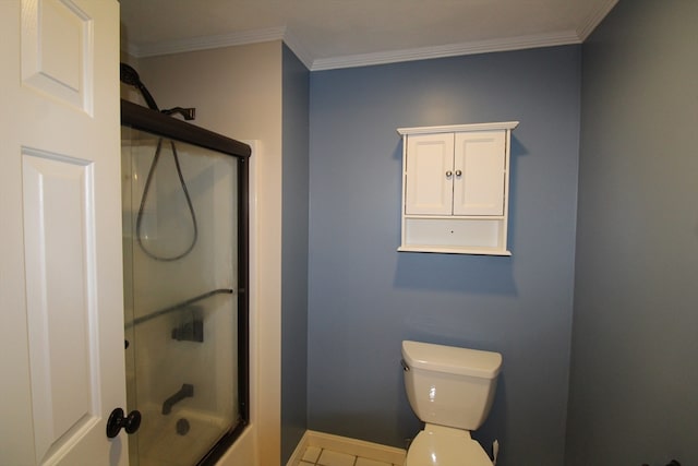 bathroom featuring toilet, crown molding, and a shower with shower door