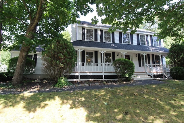 colonial-style house with a front lawn and covered porch