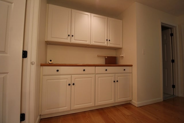 kitchen with white cabinetry and hardwood / wood-style flooring