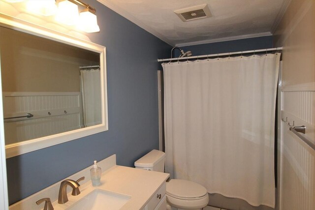 bathroom featuring a shower with curtain, toilet, ornamental molding, and vanity